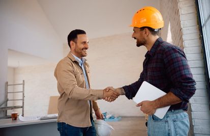 man shaking hands with home contractor