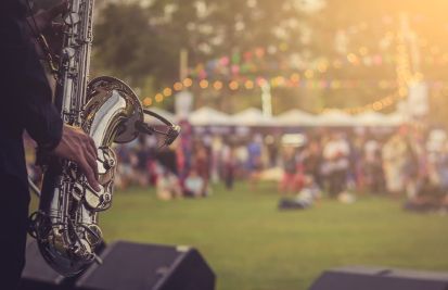 man with saxophone at outdoor festival prevent chargebacks and fraud