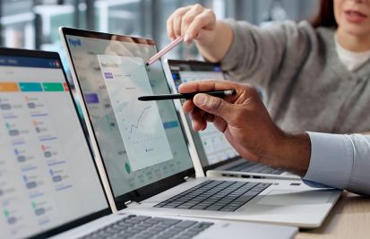 Business owners on laptop looking at payment reports