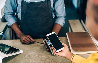 man accepting payment on mobile reader