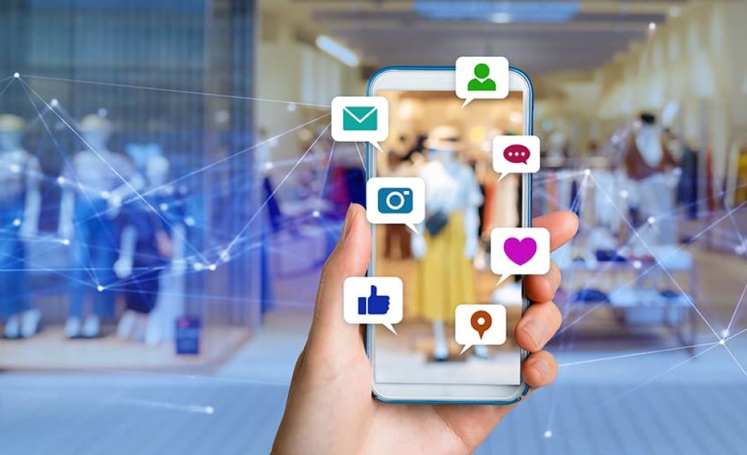 man holding mobile home with Instagram likes and social media icons