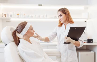 Young woman at med spa consults with a beautician