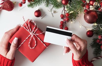 holiday season loyalty program with woman holding gift card