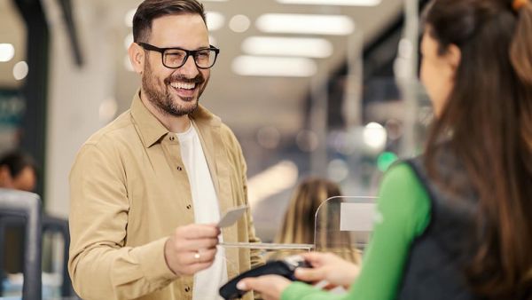 Man making a purchase at store with credit card wireless payment