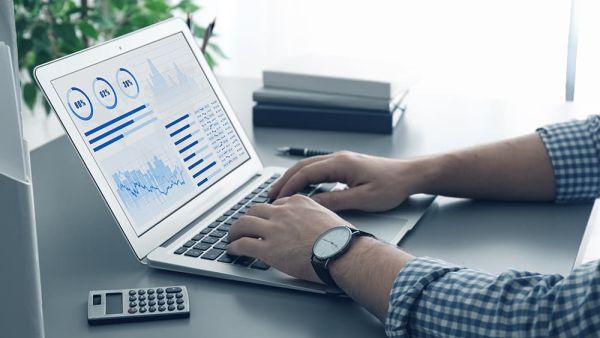 man on laptop with quoting software for payment processing