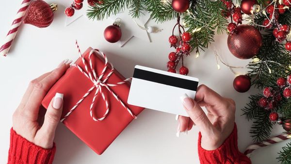holiday season loyalty program with woman holding gift card