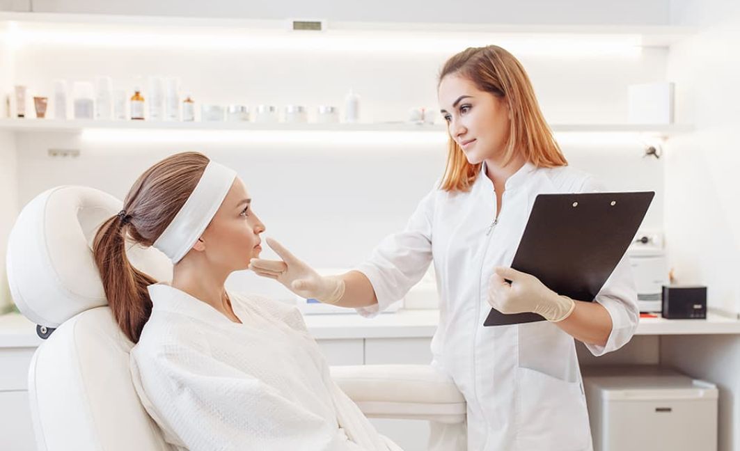 Young woman at med spa consults with a beautician