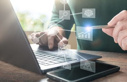 Man on computer integrating payments between in-store and online sales