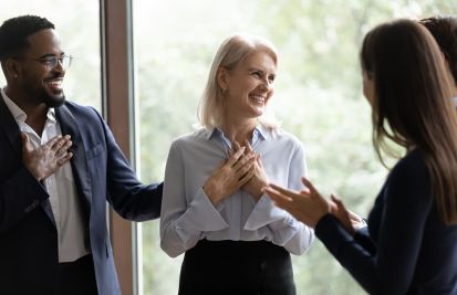 Employees celebrating colleague achievement