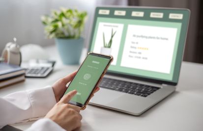 Woman on phone and laptop making purchases with customized payment links