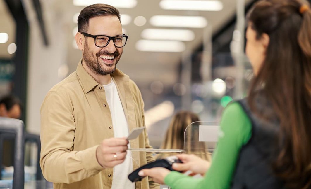 Man making a purchase at store with credit card wireless payment