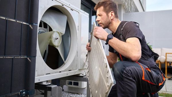 HVAC contractor reparing air conditioning system