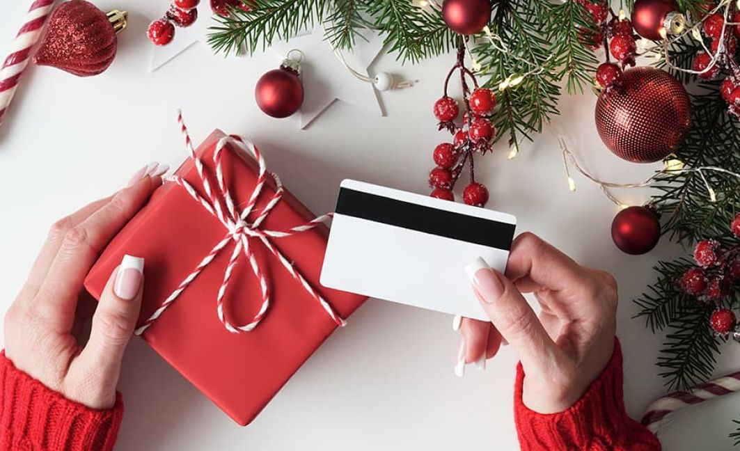 holiday season loyalty program with woman holding gift card