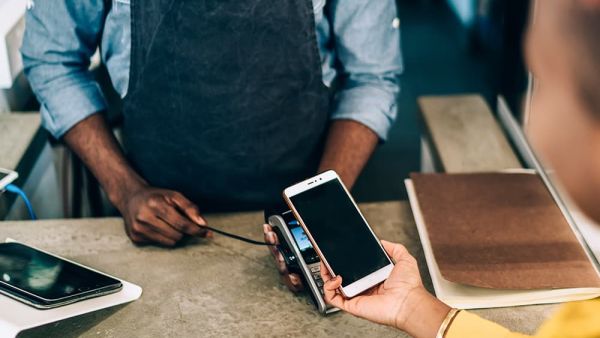 man accepting payment on mobile reader