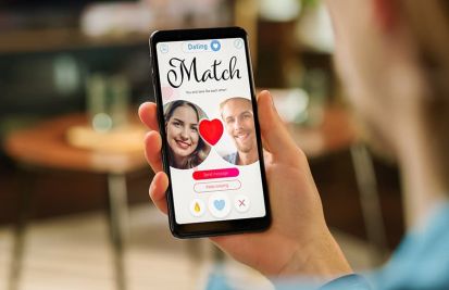 Woman looking at dating phone app with a match