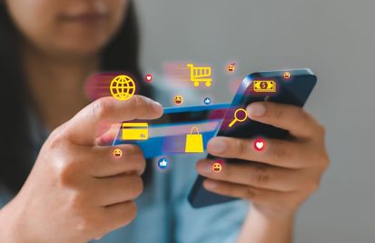Woman on phone making purchases online with her credit card