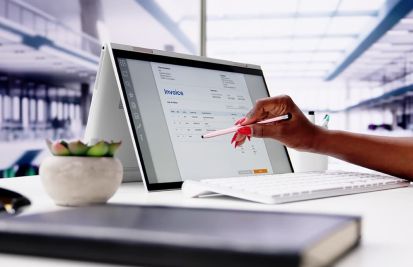 Woman using tablet to generate invoices for her clients