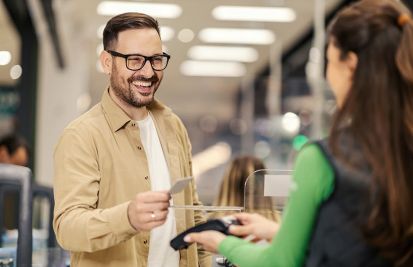Man making a purchase at store with credit card wireless payment