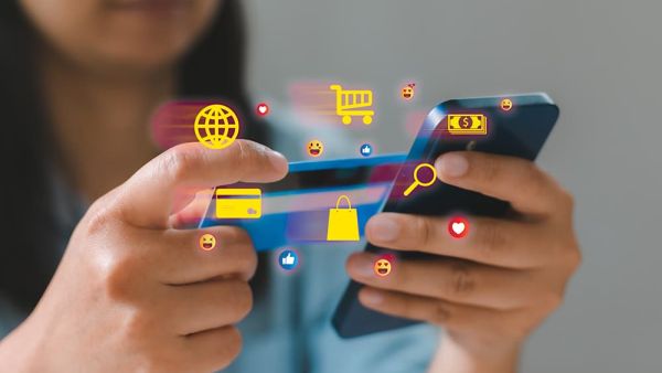 Woman on phone making purchases online with her credit card