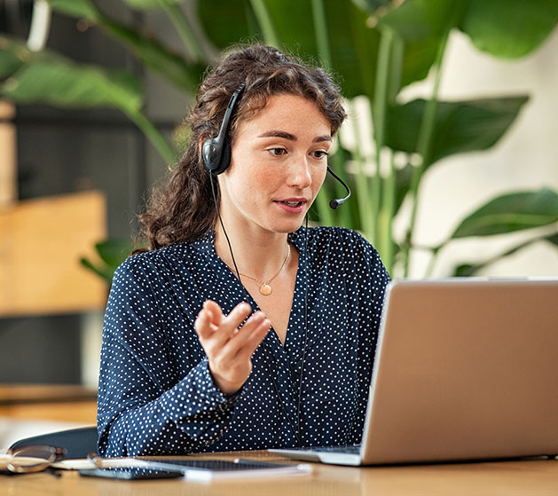 A woman in headphones providing customer support with North's Payments Hub