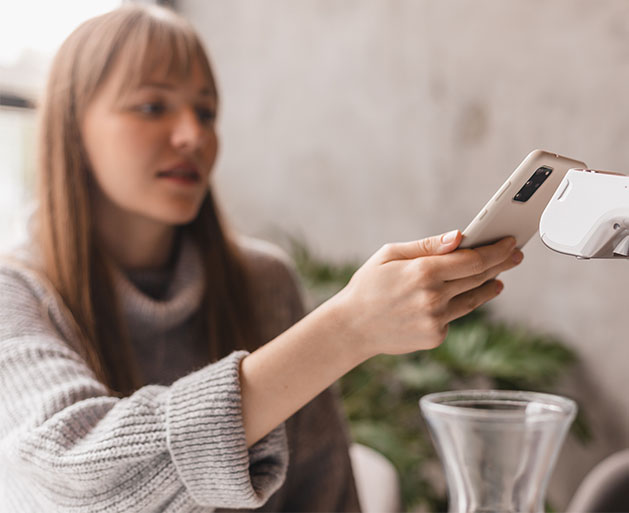 A customer making an offline payment with a mobile device at a salon