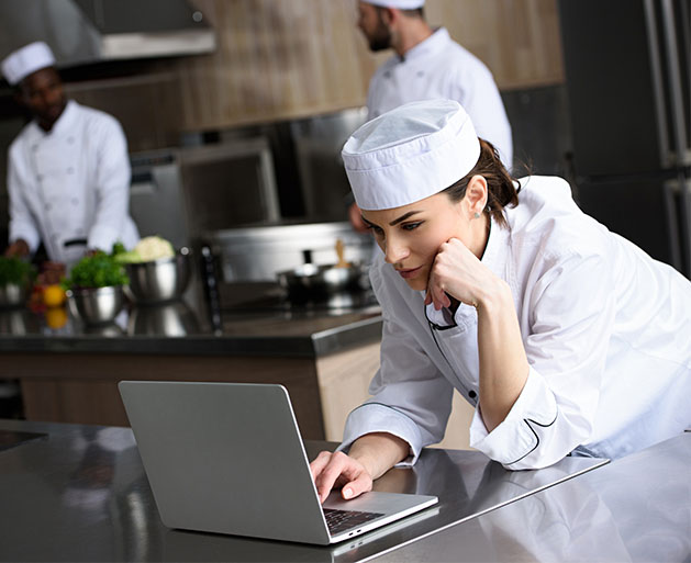 A chef using North POS technology for better kitchen communication