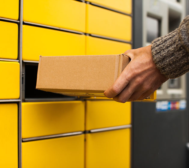 A person taking a package out of a mail locker 