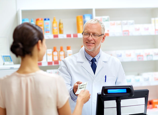 A pharmacist handing cash change to a customer