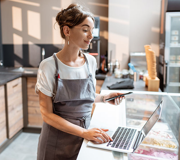 A bakery owner reviewing her online's store's online commander center from North's POS systems