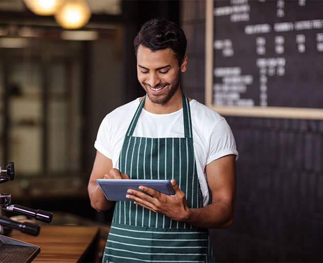 A barista reviewing orders with ease thanks to North's easy to use POS ticket system