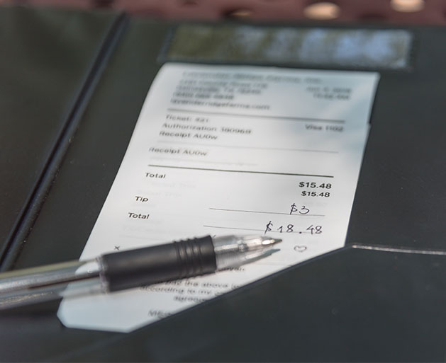 A restaurant receipt with tip added to it