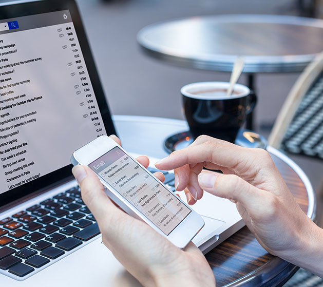 A person on their phone reviewing automated email reports from North's POS systems