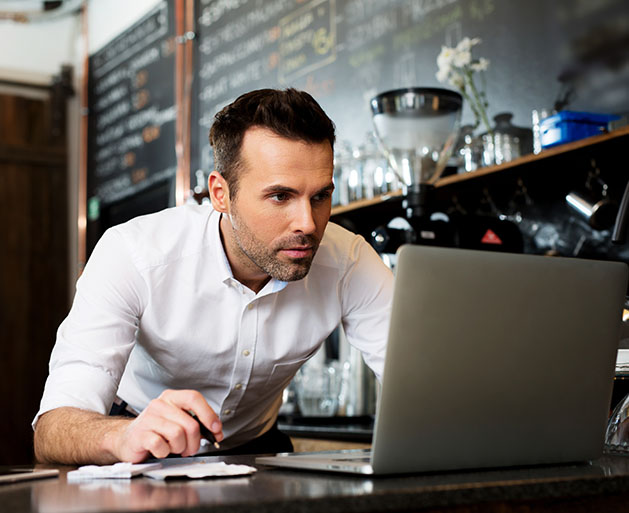 A bar owner reviewing employee management systems on North's merchant portal