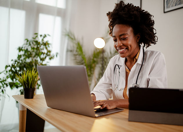 A doctor providing medical advice through a telemedicine call on her laptop